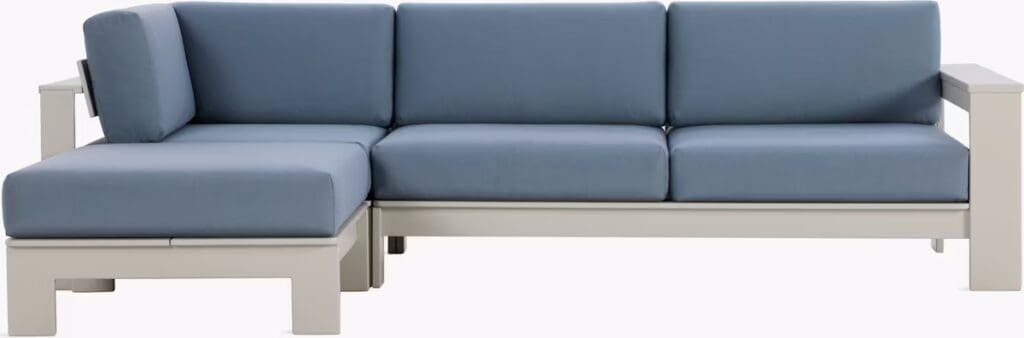 Modern outdoor sectional sofa with light blue cushions and a sleek, neutral frame, designed for comfortable lounging.