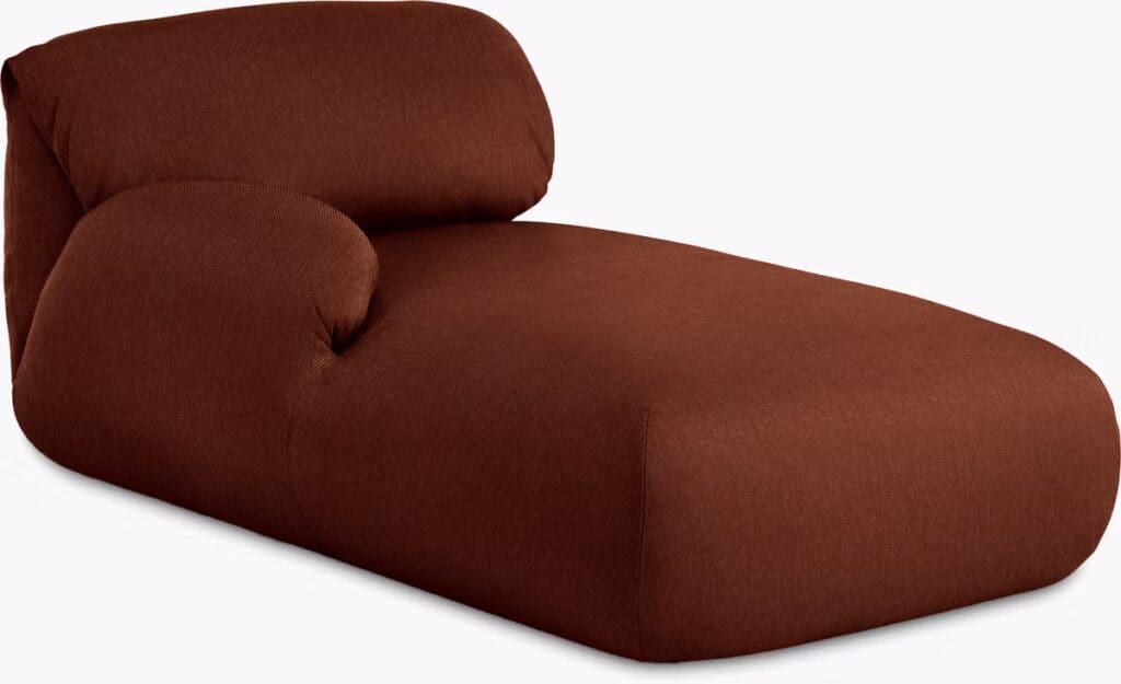 A modern chaise lounge in a rich brown fabric, featuring a curvy design for a comfortable seating experience.