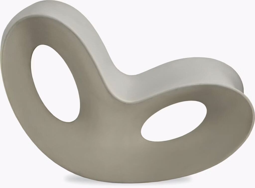 A modern decorative chair with a flowing, organic shape and two circular cutouts for added style.