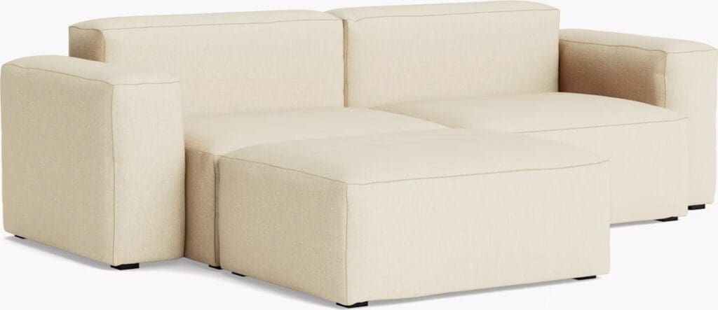 Contemporary soft beige sectional sofa with plush cushions, featuring a modern design and clean lines.
