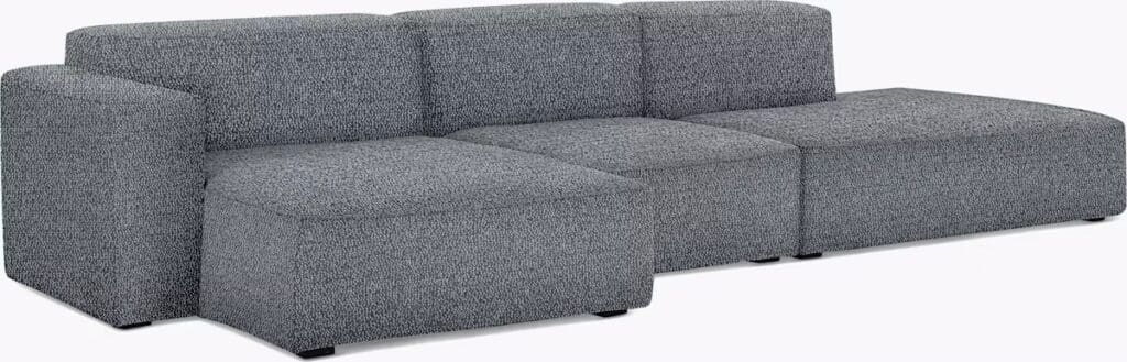 A modern sectional sofa in a gray fabric, featuring a unique modular design with square-shaped cushions and a sleek silhouette.