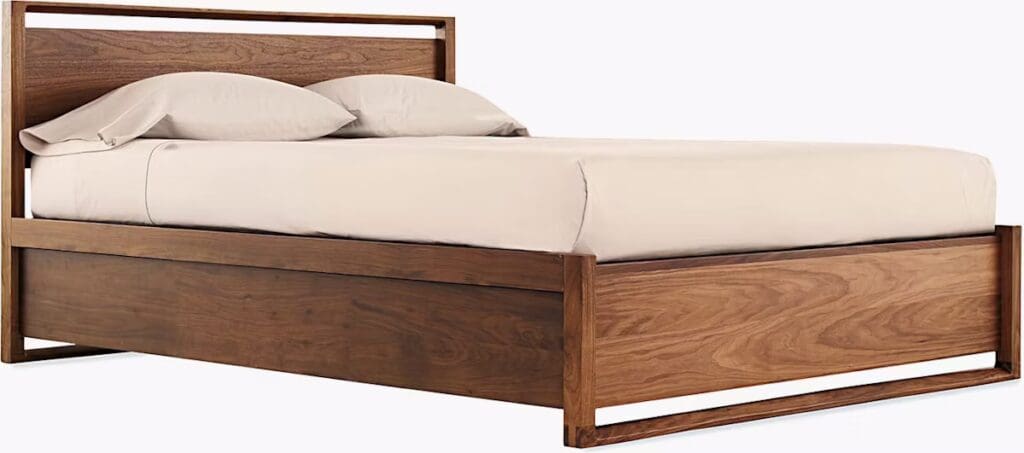 A modern wooden bed frame with a simple design, featuring a headboard and beige bedding.