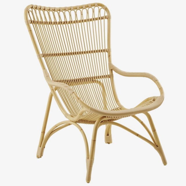 Modern rattan chair with a curved backrest and armrests, designed for outdoor seating.