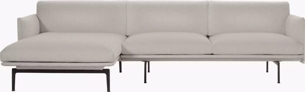 A modern sectional sofa upholstered in light gray fabric with clean lines and a minimalist design, featuring a chaise lounge on one end and supported by slim black metal legs.