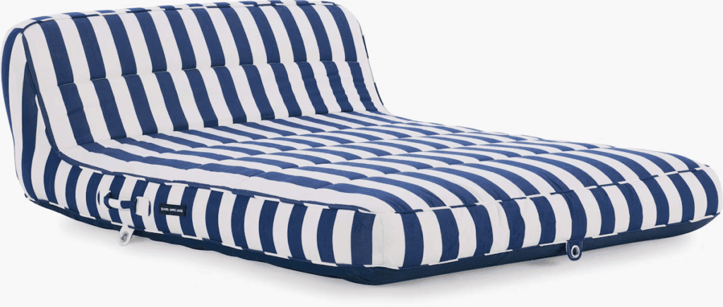 Oversized blue and white striped outdoor cushion designed for lounging.