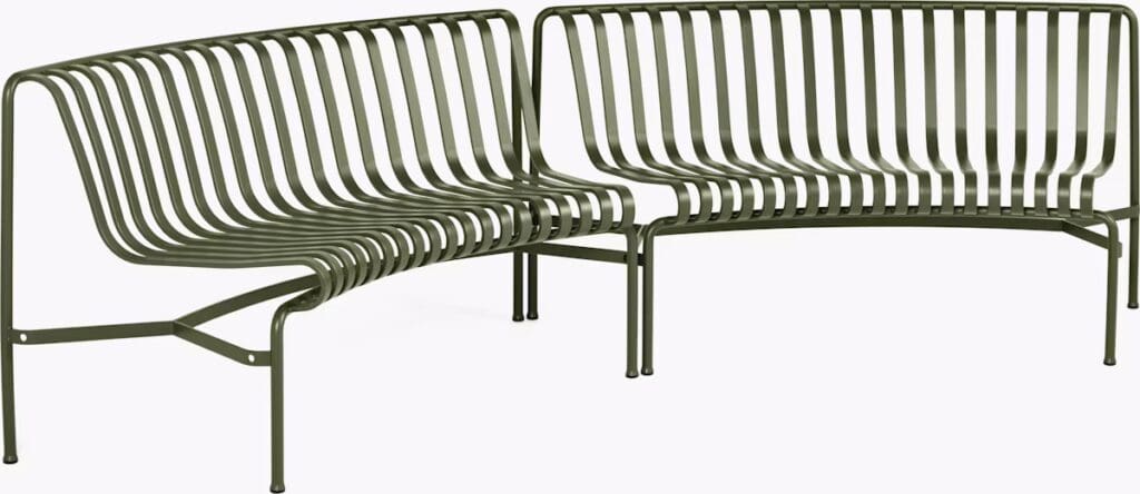 A modern green metal bench with a unique slatted design, featuring curved edges and a sleek appearance.