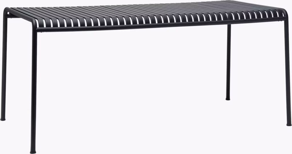 A sleek black metal dining table with horizontal slats on the top and slender legs.