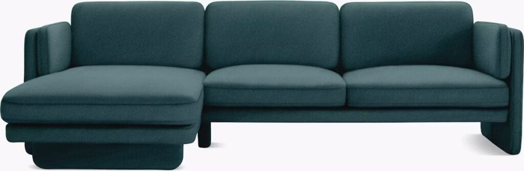 A modern teal sectional sofa with clean lines and plush cushions, designed for comfort.