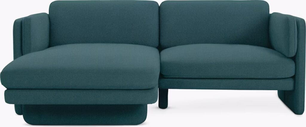 A modern chaise sectional sofa in a solid teal color with clean lines and plush cushions.