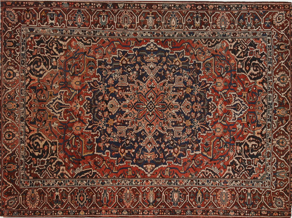 A vintage Persian carpet featuring intricate patterns in deep red, blue, and cream tones, with central floral motifs and a detailed border.