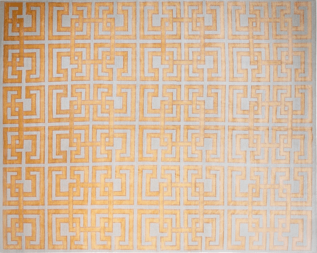 A patterned rug featuring interlocking geometric designs in shades of gold and white.