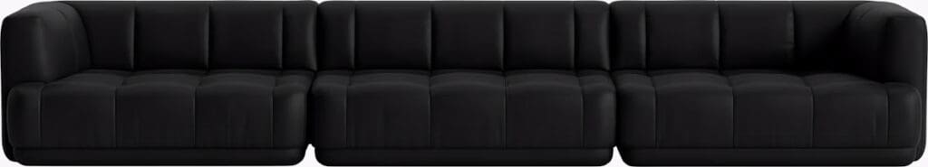 A modern black sectional sofa with a stylish tufted design.