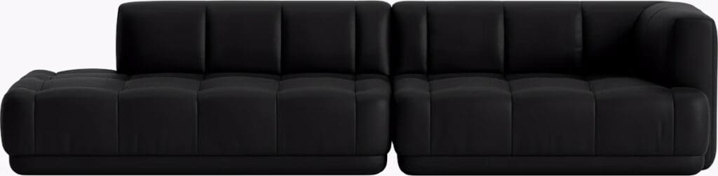 A modern black sectional sofa with tufted fabric design, featuring a chaise section on one end.