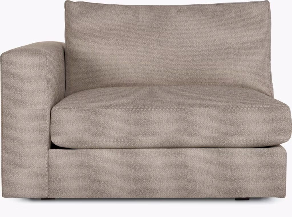 A modern beige sectional sofa with a comfortable design, featuring a low back and plush cushioning, suitable for contemporary living spaces.