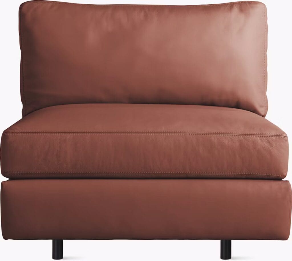 A modern brown chaise sectional sofa with a plush backrest and cushioned seat, featuring sleek metal legs.