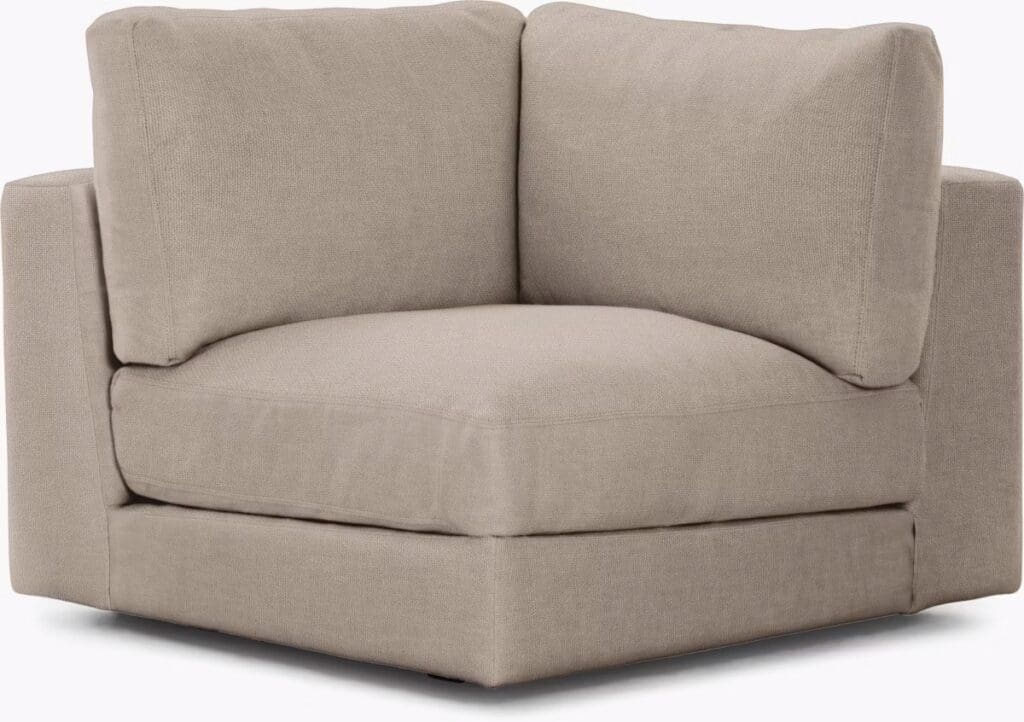 A corner sectional sofa in a neutral beige fabric with plush back and seat cushions, designed for comfort and style.
