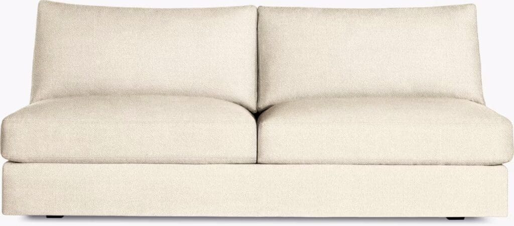 A modern chaise sectional sofa upholstered in a light beige fabric, featuring plush cushions designed for comfort.