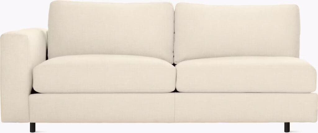 A modern beige sectional sofa with plush cushions, featuring a minimalist design suitable for contemporary living spaces.