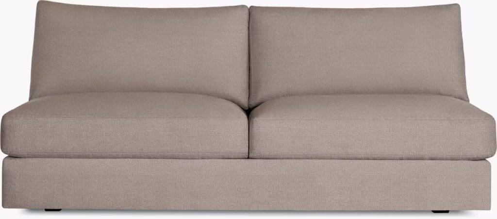 A modern, plush sectional sofa in a light brown fabric, featuring two wide seating cushions and a simple, streamlined design.