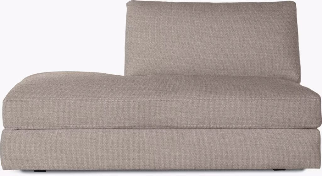 A comfortable chaise sectional in a light gray fabric, featuring a low back and plush cushions, showcasing modern design elements.