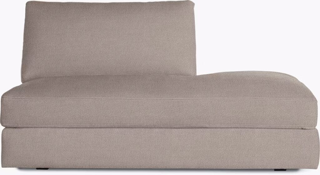 A chaise sectional sofa in a light brown fabric, featuring a low backrest and clean lines, designed for comfort and relaxation.