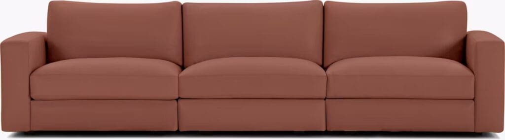 A modern brown sectional sofa with plush cushions, designed for comfort and relaxation.