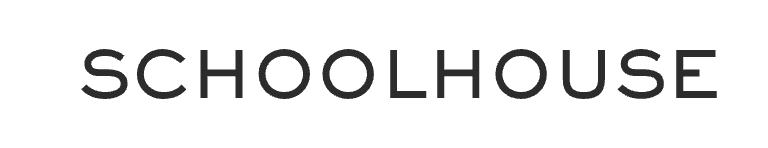 Luxurious outdoor living space with modern furniture overlooking a tropical ocean view, featuring potted plants and a bright blue sky.