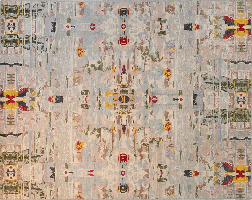 Abstract rug featuring a colorful design with intricate patterns in shades of blue, pink, red, and yellow.