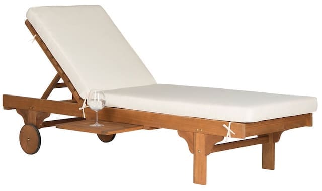 Wooden lounge chair with white cushion and a glass resting on the side table.