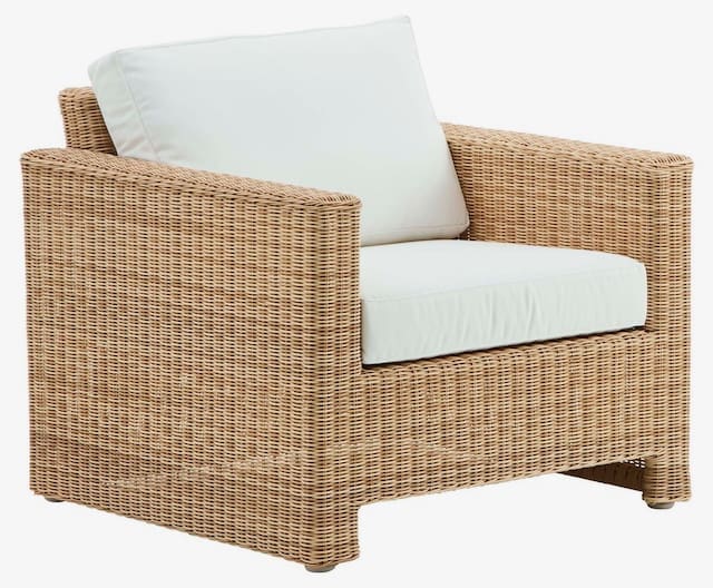 Stylish wicker outdoor armchair with a white cushion, offering a comfortable seating option for outdoor spaces.
