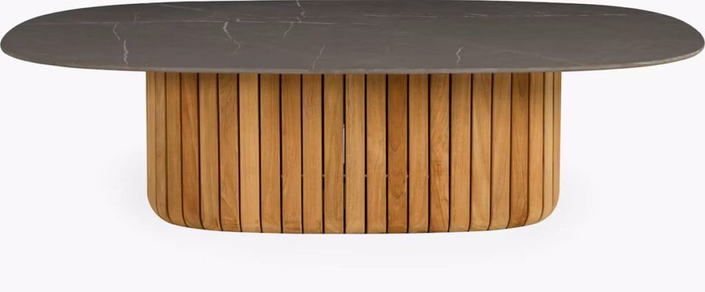 A modern coffee table featuring a round dark marble top and an artistic base made of wooden slats.