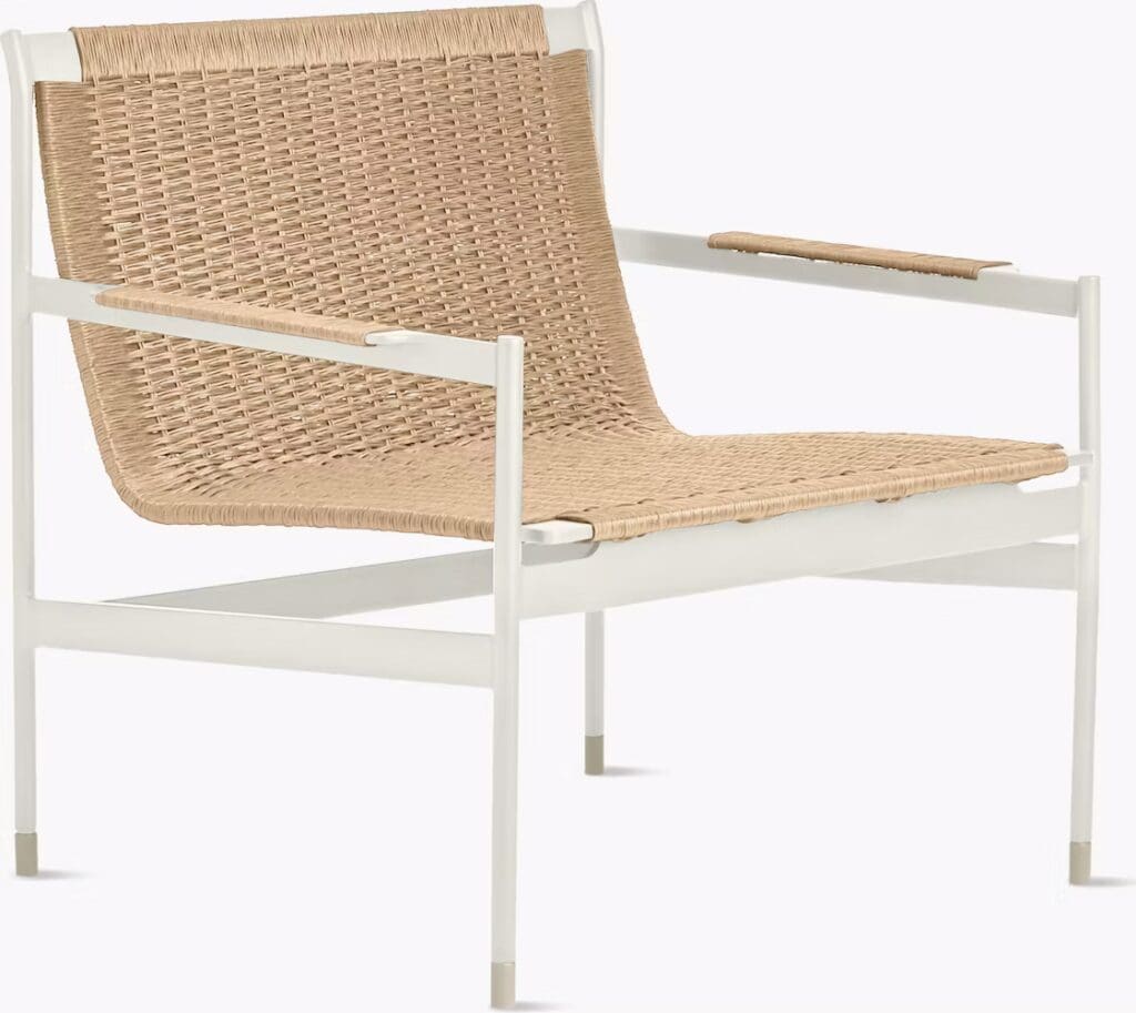 A modern chair featuring a woven natural fiber seat and backrest on a white frame, designed for contemporary living spaces.