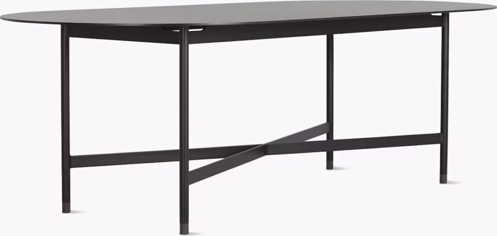 A modern oval table with a sleek dark surface and a minimalist steel frame featuring crossbar support.