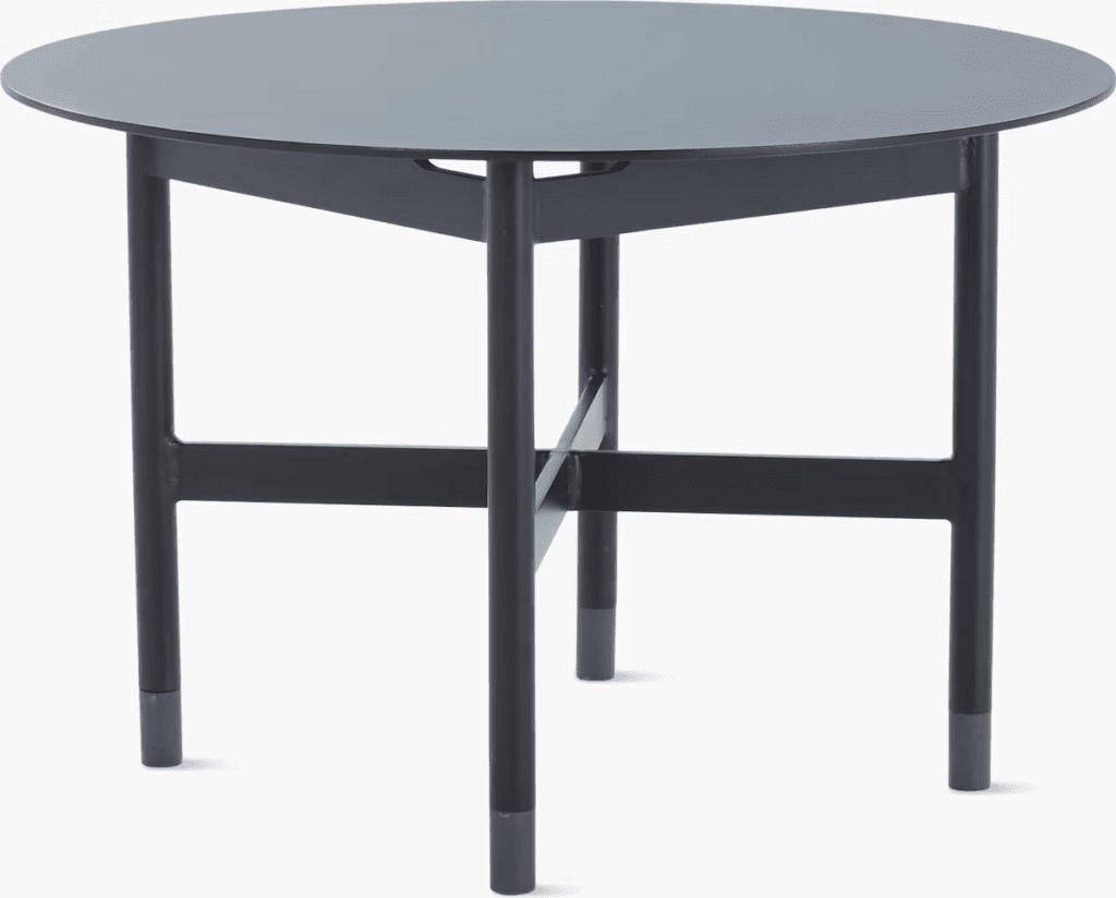 Modern round table with a sleek dark finish and minimalist design, featuring sturdy legs.