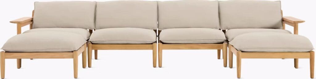 Modern sectional outdoor sofa with beige cushions and wooden frame, designed for comfort and style.