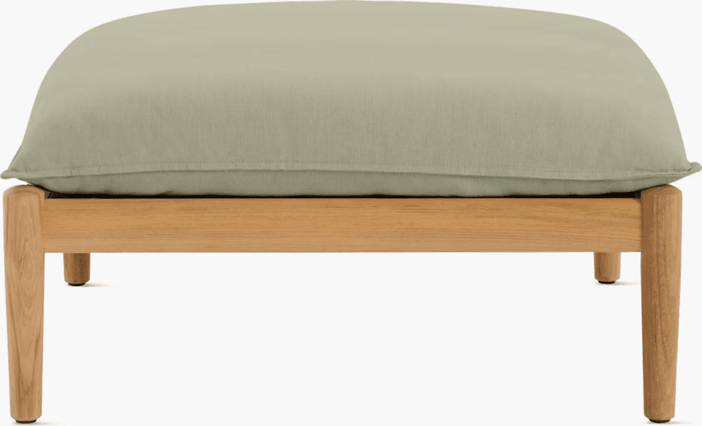 Close-up of a modern outdoor ottoman with a green cushion and wooden frame, designed for luxury outdoor living.