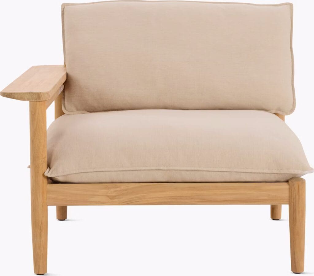 A modern armchair with a beige cushion and wooden frame, featuring a simple design and a single armrest.