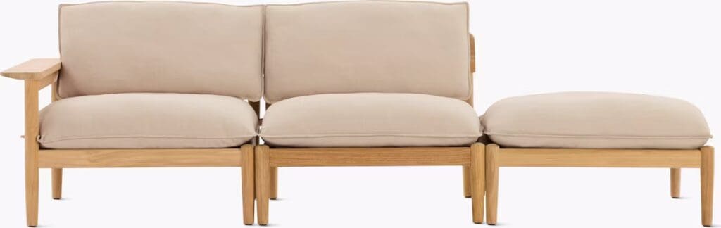 A modern outdoor sectional sofa with beige cushions and wooden frame, designed for relaxation and style.