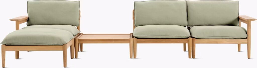 Modern outdoor seating set featuring a green cushioned sofa and a side table, designed for comfort and luxury.