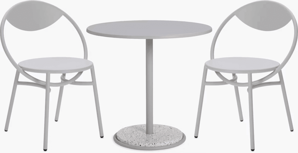 Minimalist outdoor dining set featuring a round table with a terrazzo base and two matching white chairs.
