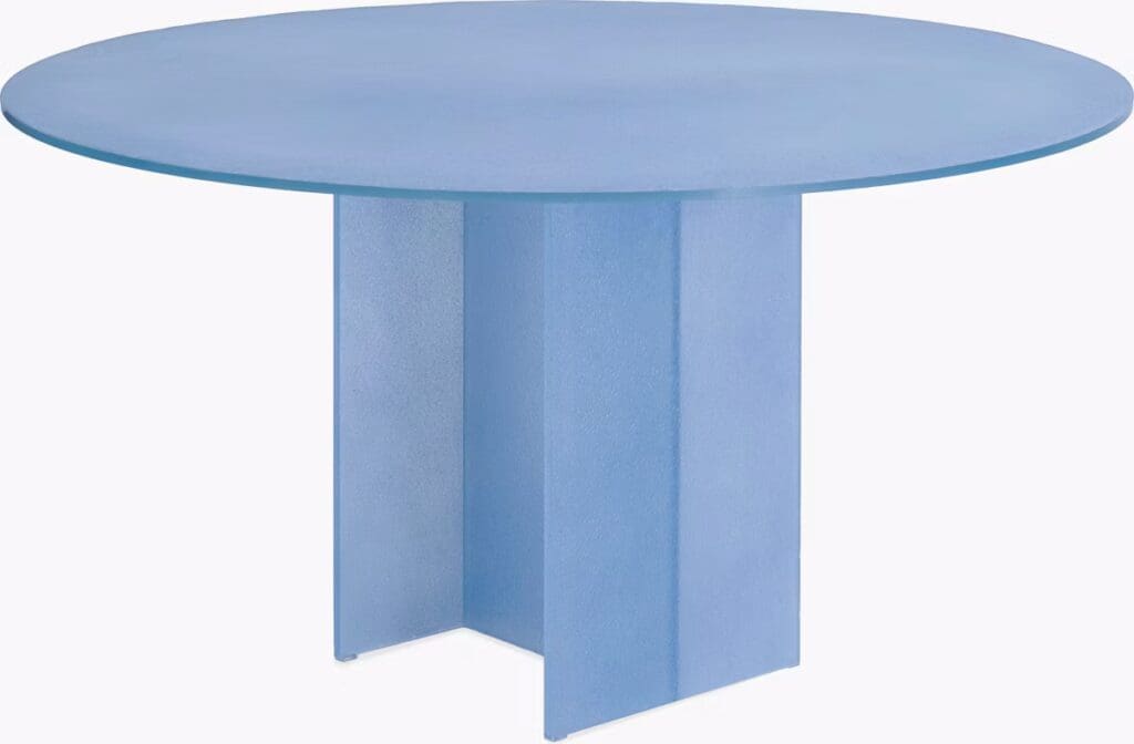 A round dining table with a smooth blue top and a geometric pedestal base, showcasing a modern and minimalist design.