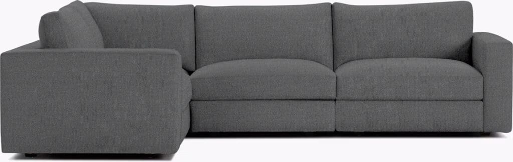 A modern gray sectional sofa with clean lines and a minimalist design, featuring plump cushions and a contemporary aesthetic.
