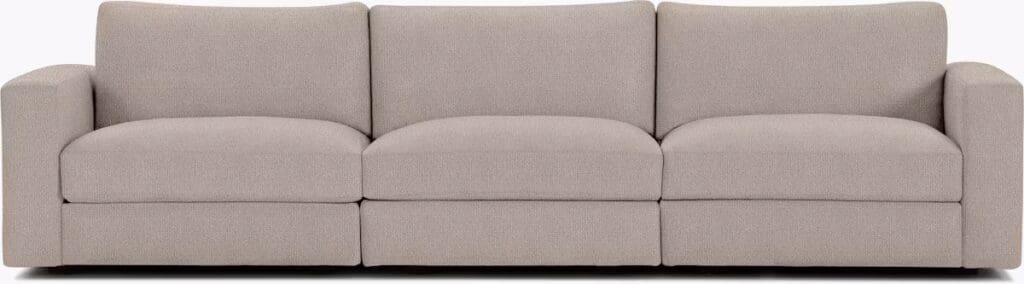 A stylish and modern light grey sofa with three plush seats and minimalistic design.