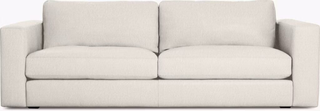 A modern, minimalist beige sofa with clean lines and plush cushions, emphasizing comfort and elegant design.