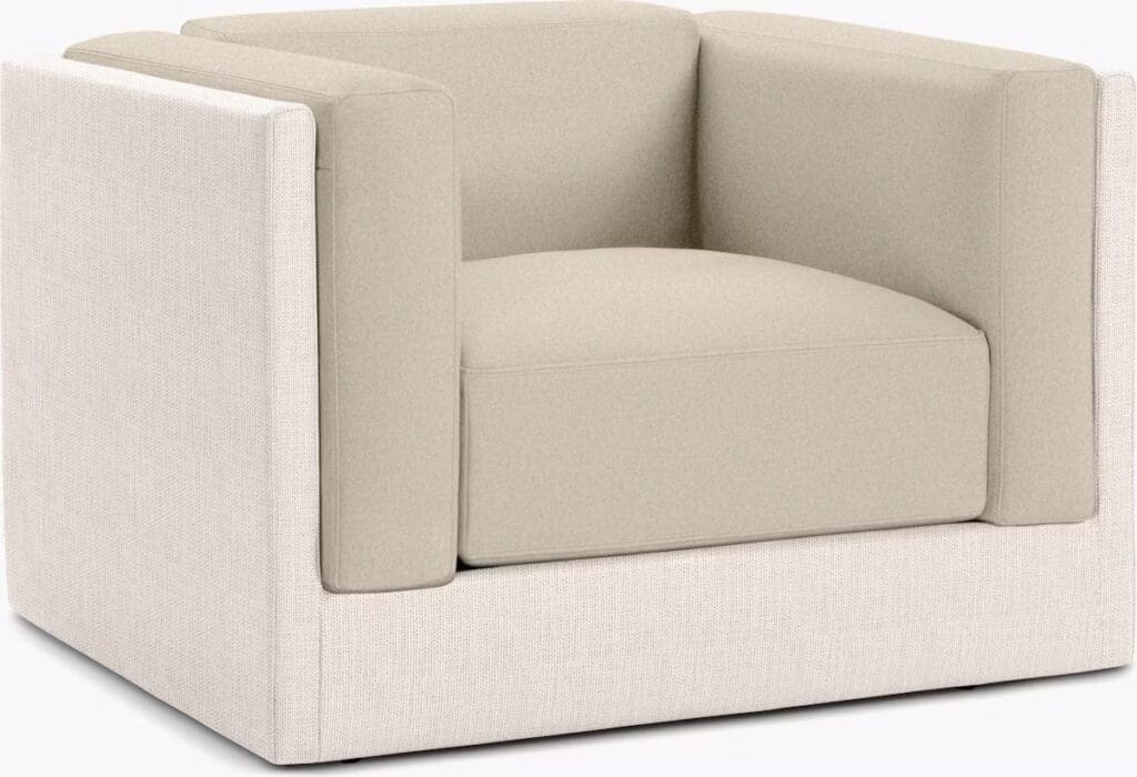 A modern armchair with a minimalist design, featuring a beige cushion and a contrasting light fabric exterior.
