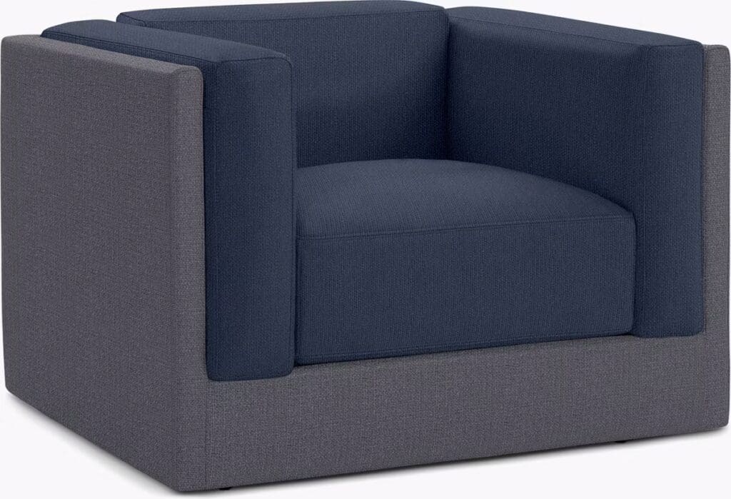 Modern armchair with a boxy design featuring a mix of dark blue and gray upholstery.