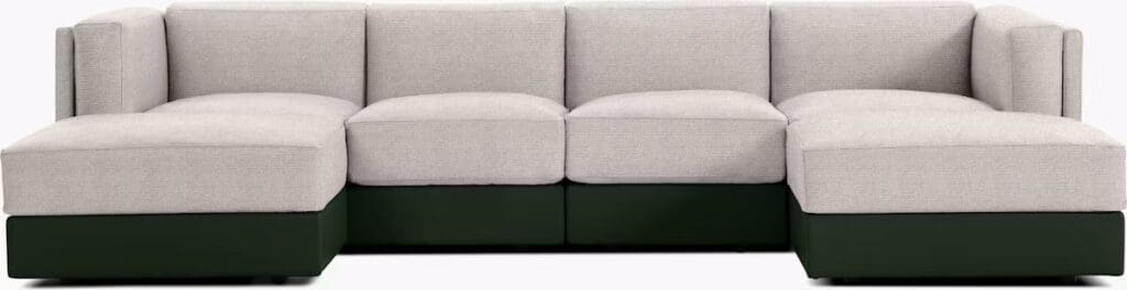 Sectional sofa featuring a light gray fabric upholstery with a dark green base, showcasing a modern and minimalist design.