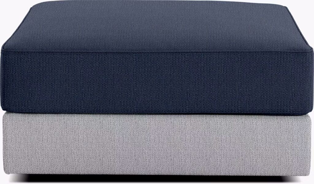 Stacked sofa cushions in dark navy blue and light gray textures, showcasing materials for customizable seating options.