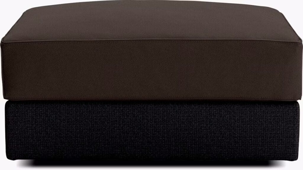 Stacked cushions featuring a dark brown leather top layer and a black fabric bottom layer, showcasing a modern design.