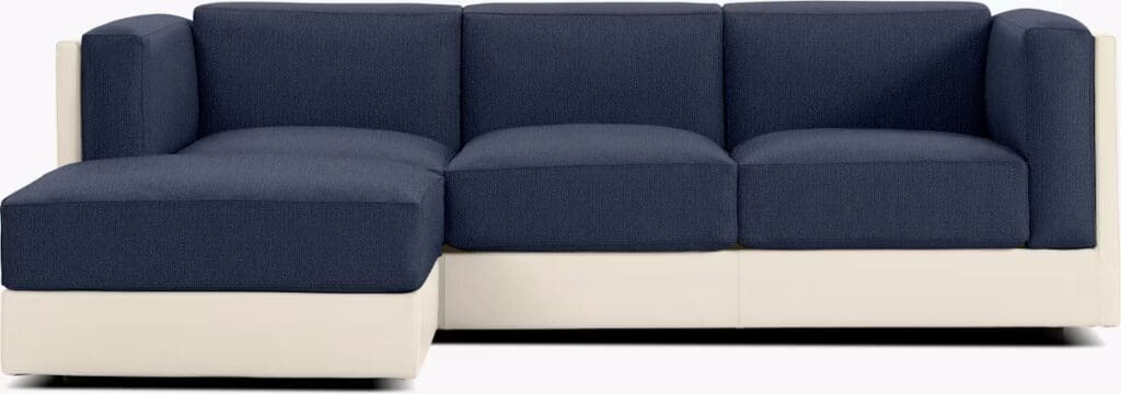 Modern sectional sofa featuring a deep blue upholstery and a light-colored base.
